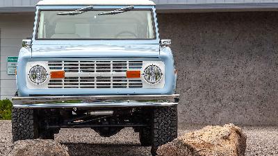 Factory early Bronco chrome bumper on blue classic Ford Bronco.